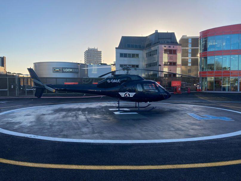 Eurocopter AS355 Twin Squirrel on the helipad at London Heliport, Battersea, at dusk