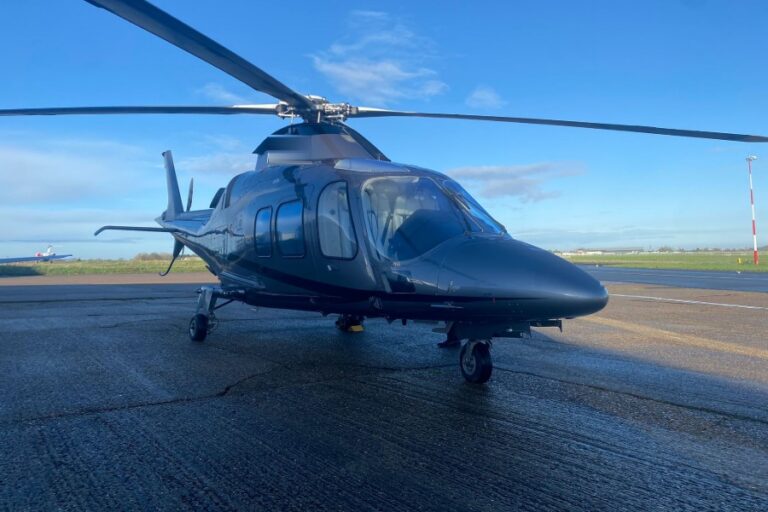 Agusta 109 Grand twin-engine executive helicopter on the apron, ready for charter from London