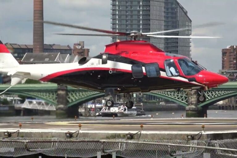 Agusta 109 Grand helicopter lifting off from London Heliport, Battersea, on a private charter flight