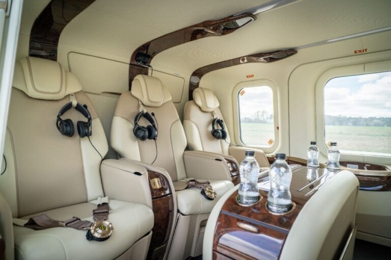 Leather VIP seats with headsets and a polished-wood table inside the Leonardo AW139 helicopter