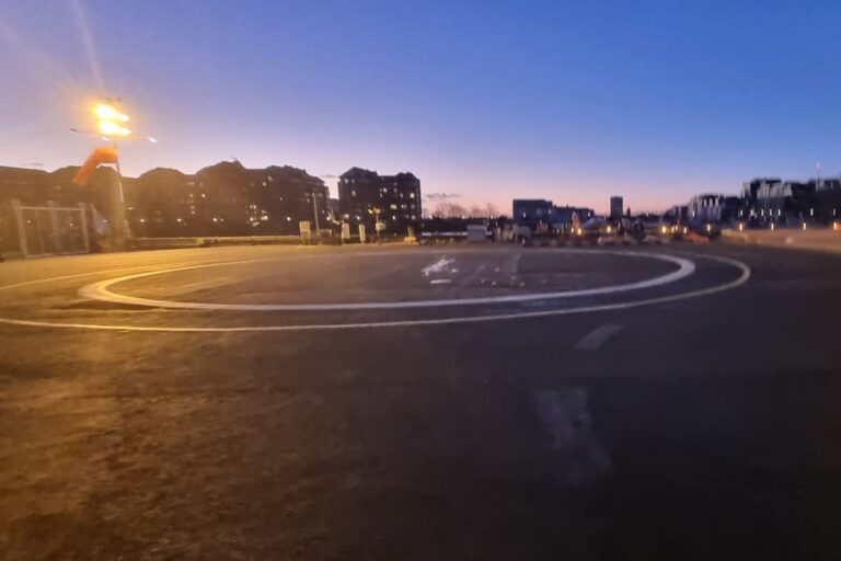 The landing pad at London Heliport, Battersea, lit up after sunset