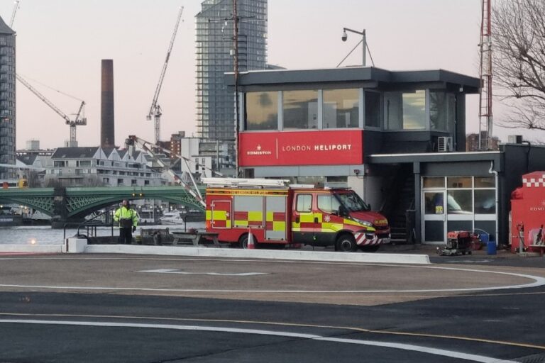 London Heliport control building, fire crew and helipad beside the River Thames at Battersea